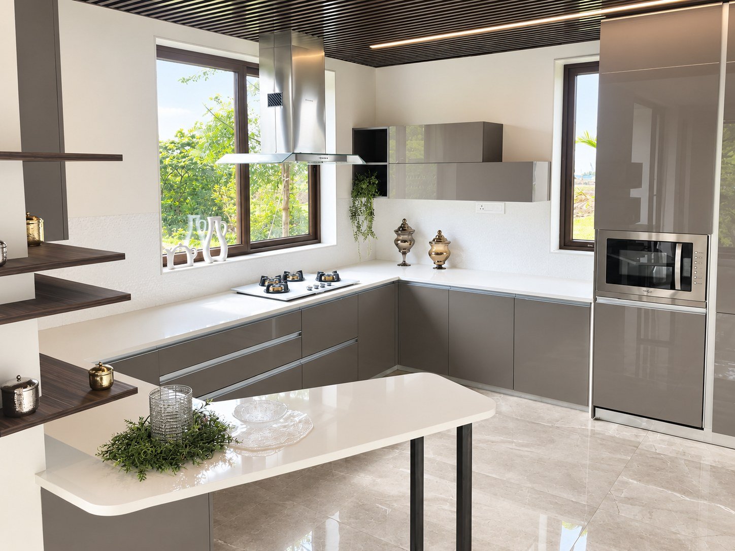 Grey modular kitchen with white worktops and a breakfast counter.