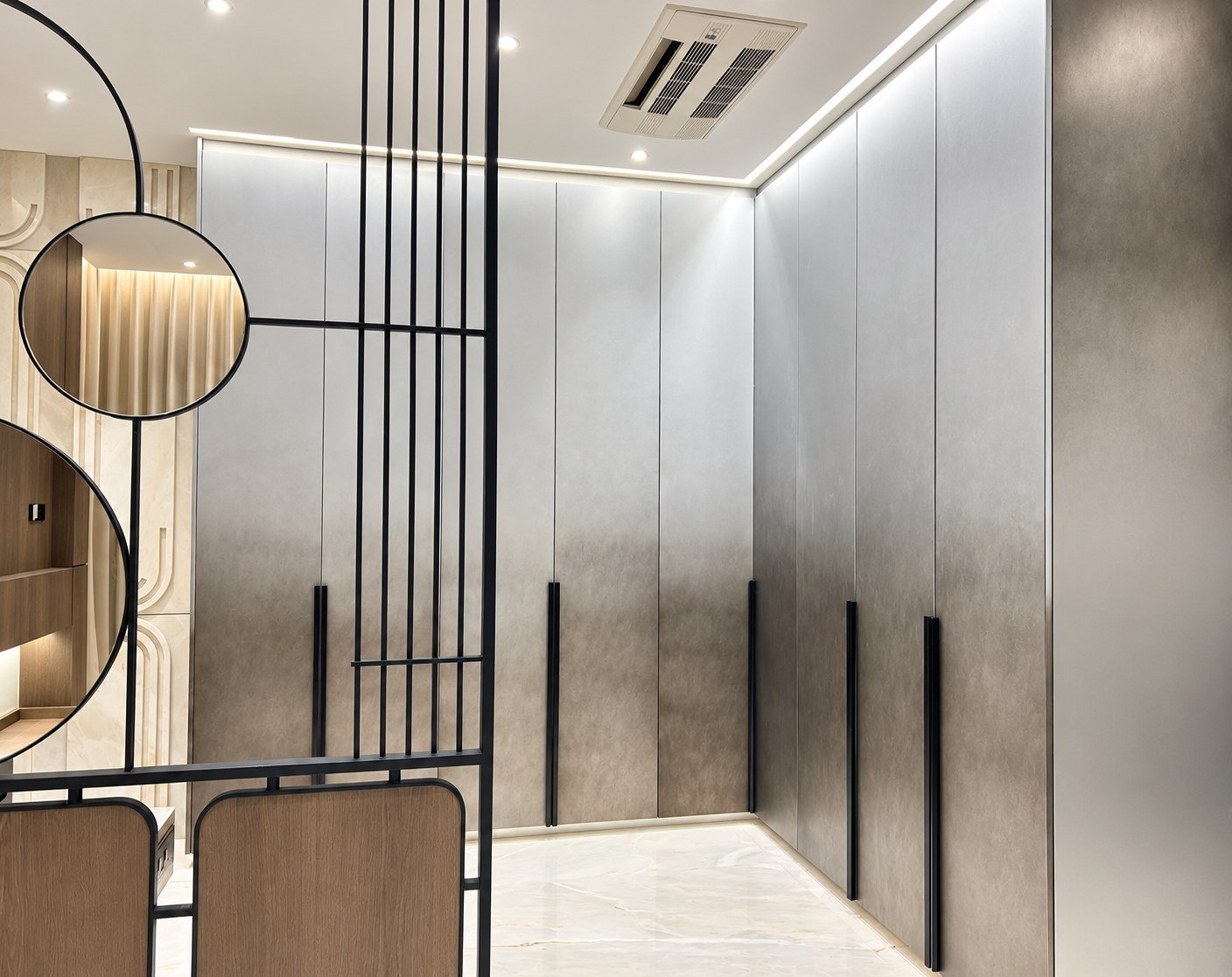 Grey fitted wardrobes with mottled fronts and slim black handles.
